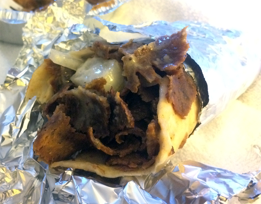 Halifax donair wrapped in a flatbread in a kitchen foil cover</a>