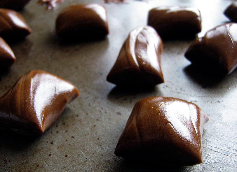 pieces of home-made molasses taffy on a baking tray