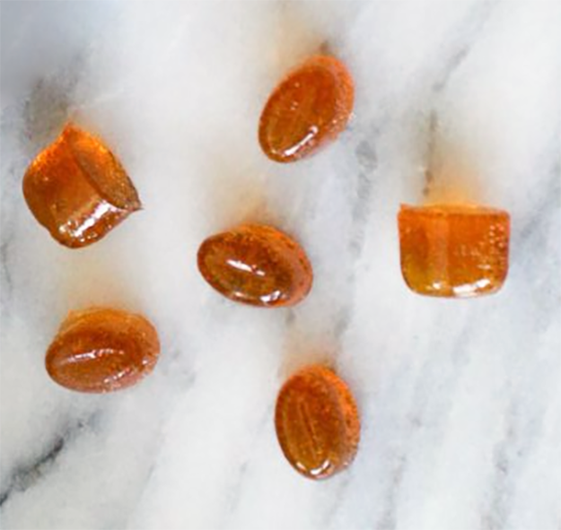 golden pieces of horehound candy on a marble slab