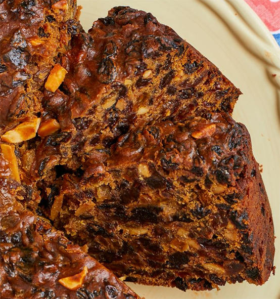 two slices of boiled fruit cake removed from the main cake and on a plate