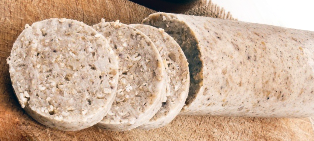 Irish white pudding with three slices cut off the end