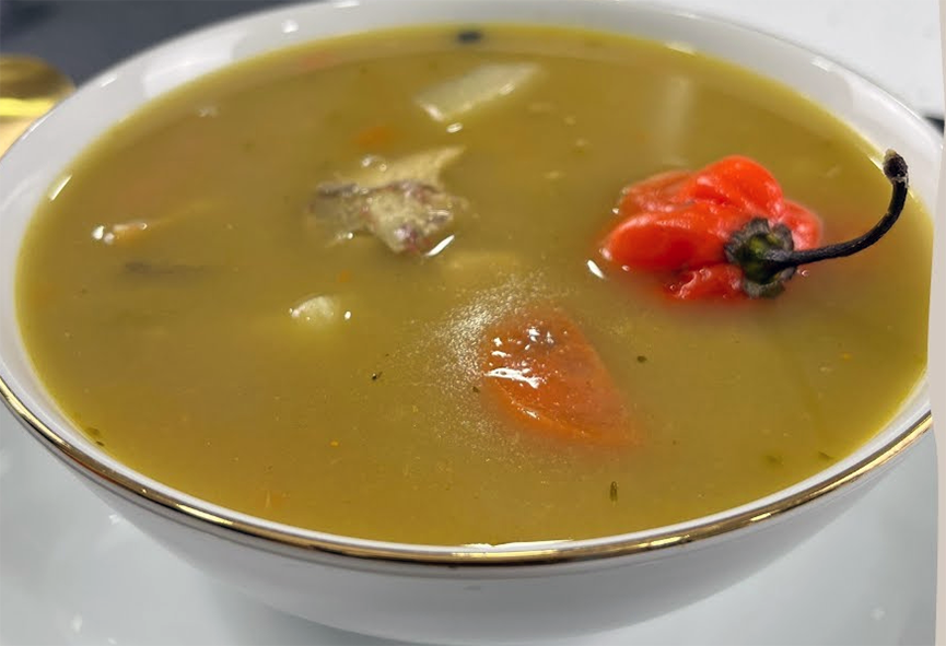 jamaican fish tea with a scotch bonnet chilli in a soup bowl