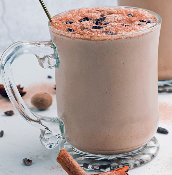 Jamaican hot chocolate served in a glass mug