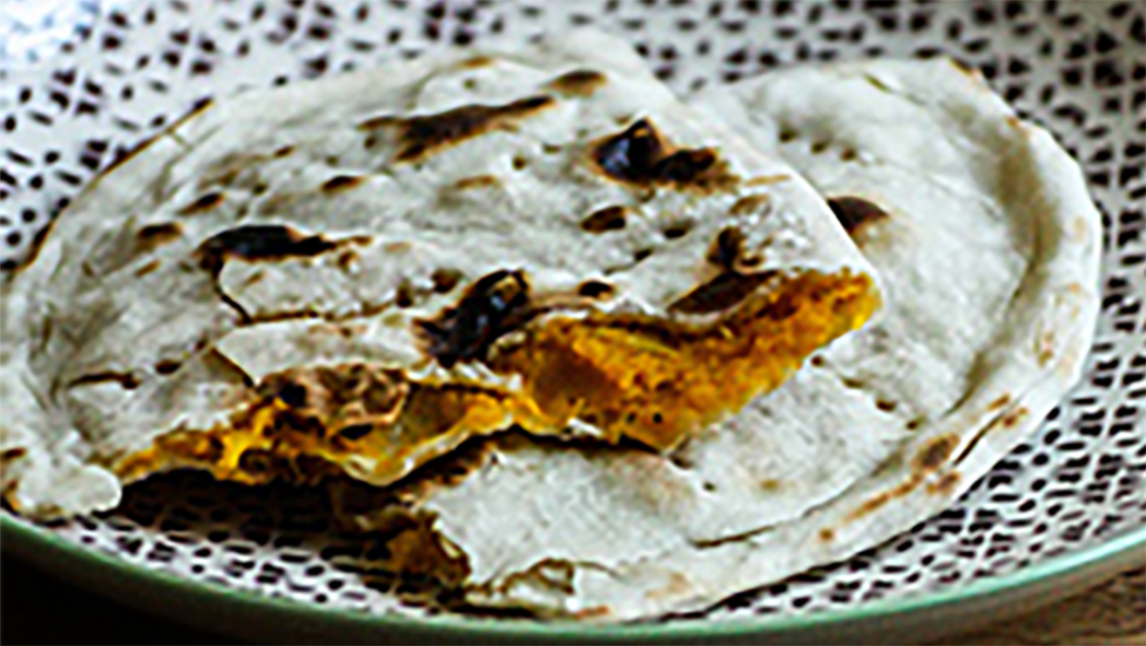 Turkmenistan butternut squash pastry torn open to reveal the filling