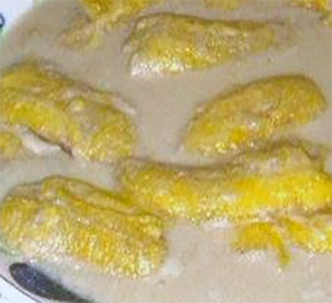 bananas served in coconut milk in a bowl
