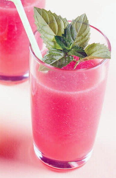 watermelon and lemon sherbet smoothie with a sprig of mint in a glass