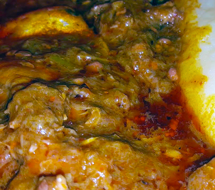 Liberian red oil okra soup with fish served on a plate