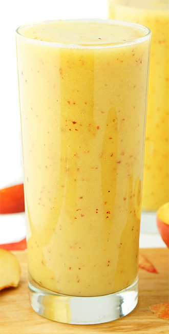 mango and peach smoothie in a tall glass