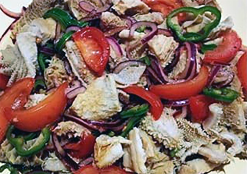 chadian salad of boiled tripe with tomato, red onion, bell pepper and sliced chillies