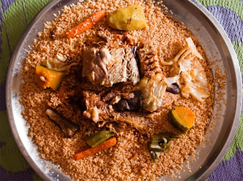 Mauritian Thieboudienne of broken rice cooked in a tomato base topped with vegetables and fish