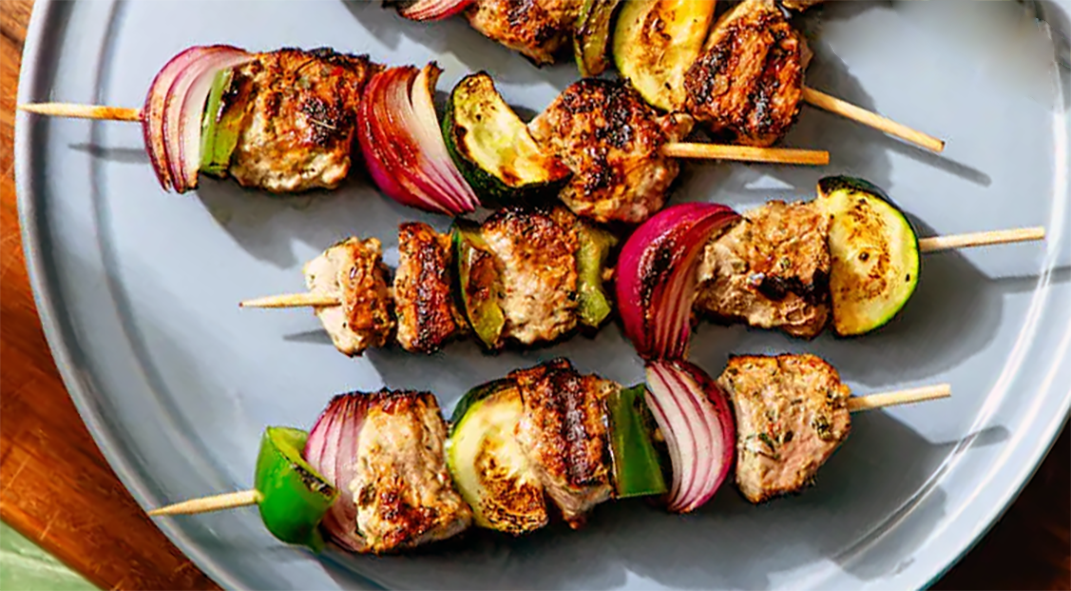 minted lamb kebabs arranged on a plate