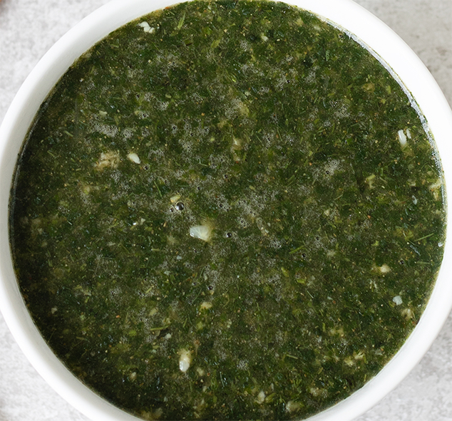 Egyptian molokhia, jute mallow leaf soup, in a white bowl