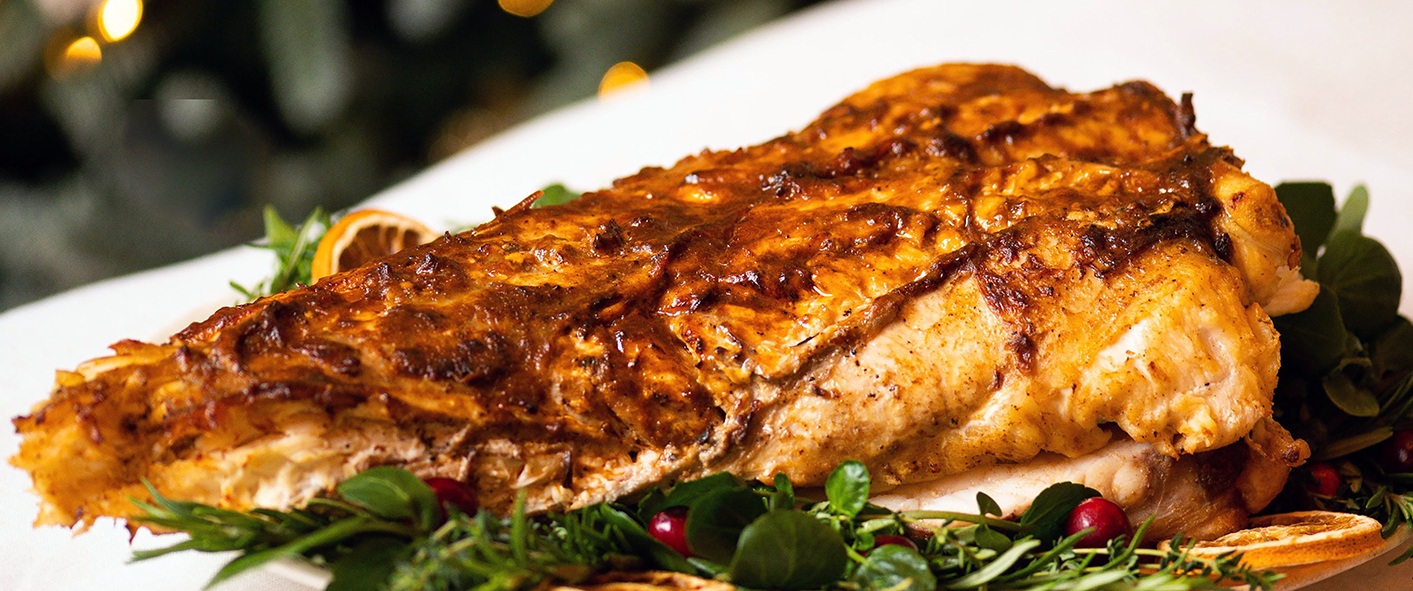 garlic-roasted whole monkfish tail served on a bed of salad leaves