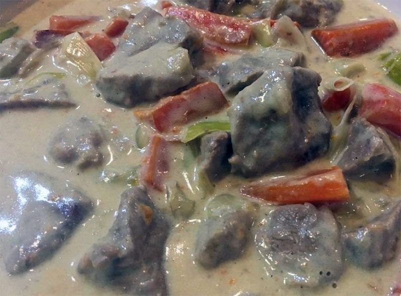 veal and vegetables in a white sauce