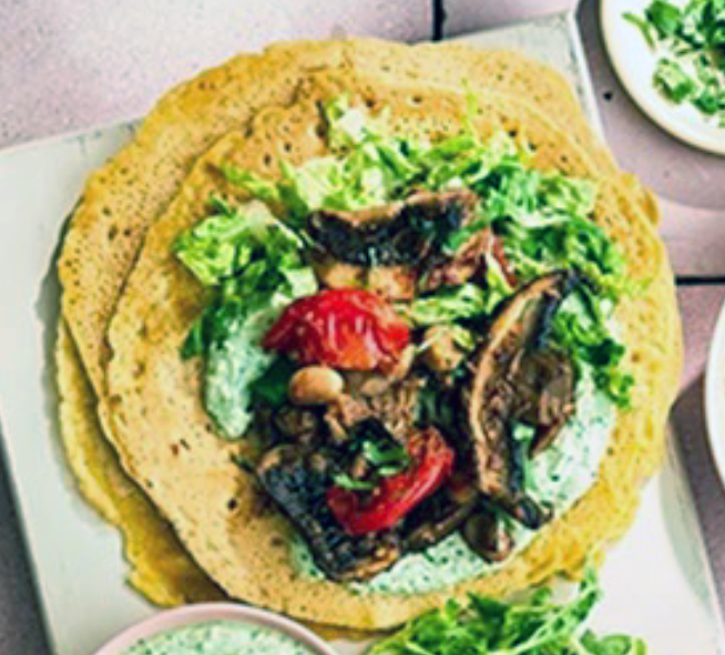 gram flour and cornmeal tacos topped with cashew cream, beans, mushrooms and coriander leaves