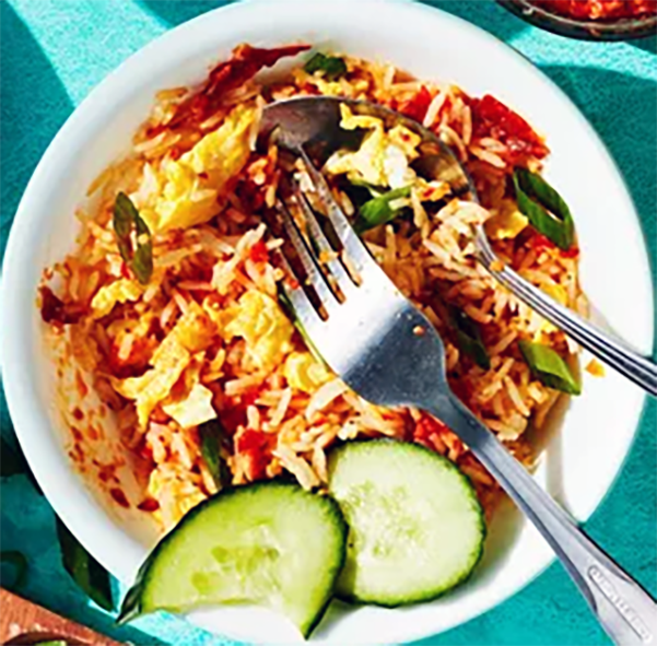 Javanese nasi goreng served in a bowl and garnished with cucumber slices