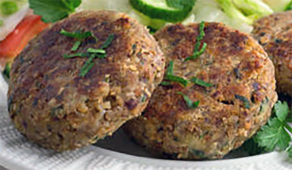 nut cutlets on a plate with salad in the background