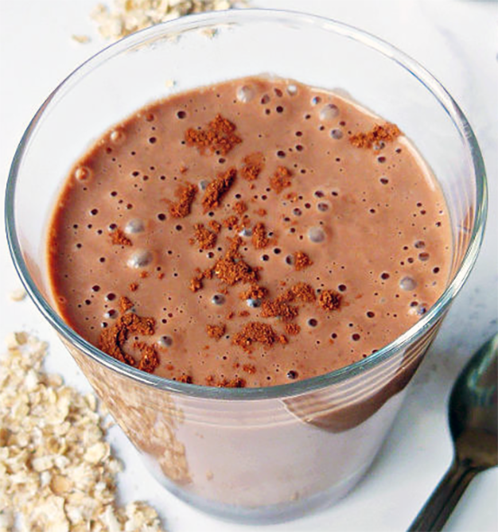 oatmeal chocolate smoothie garnished with grated chocolate in a glass