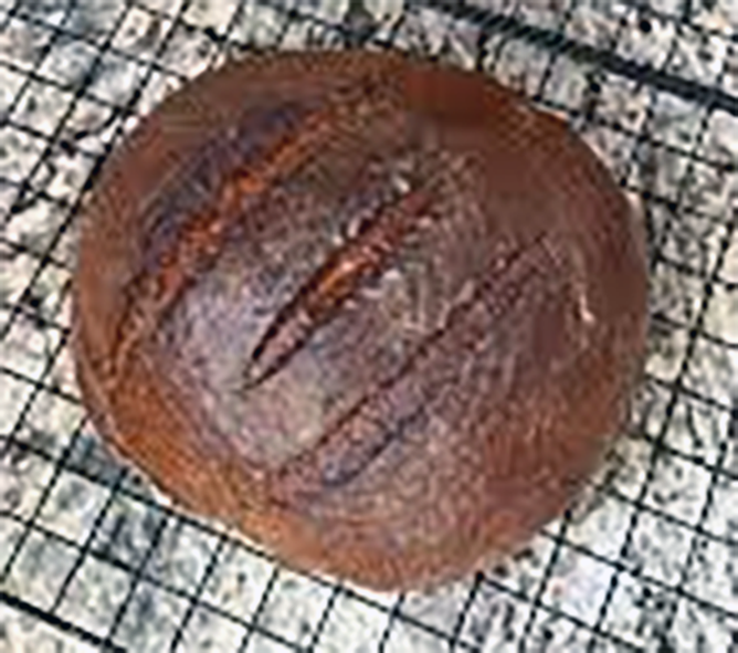 Old Milwaukee Rye Bread baked as a cob loaf cooling on a wire rack