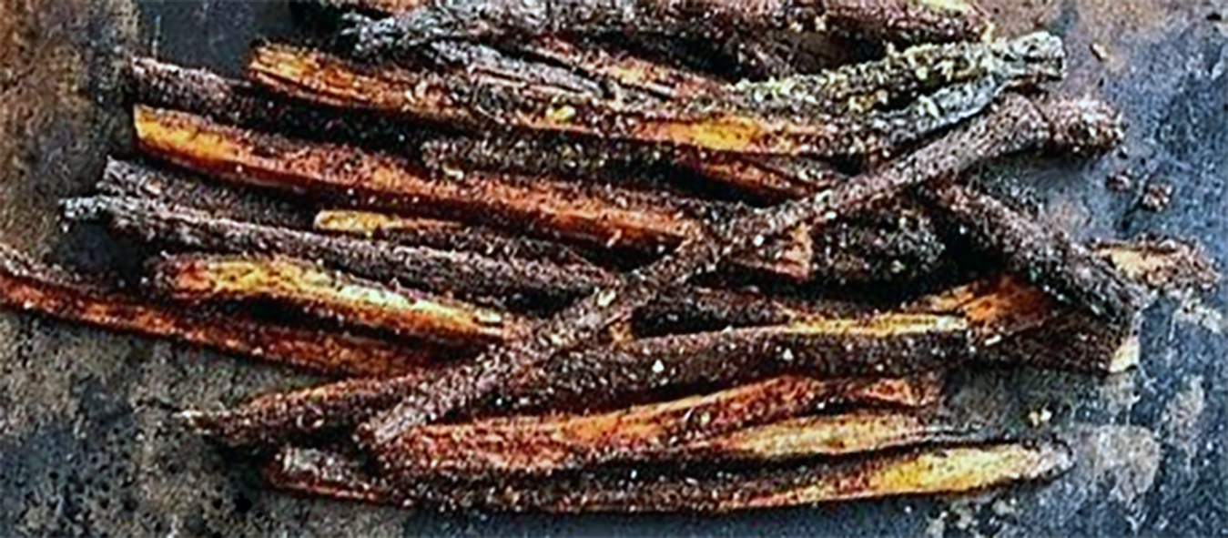 oven roasted spiced dandelion root slivers on a baking tray