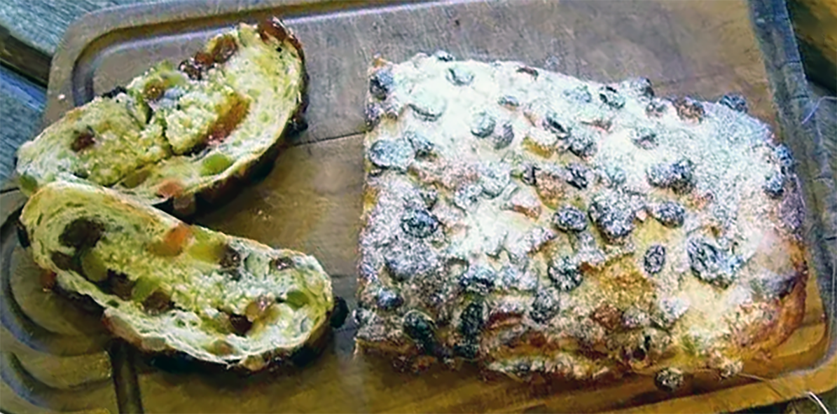 passbrod loaf with two slices cut on a chopping board