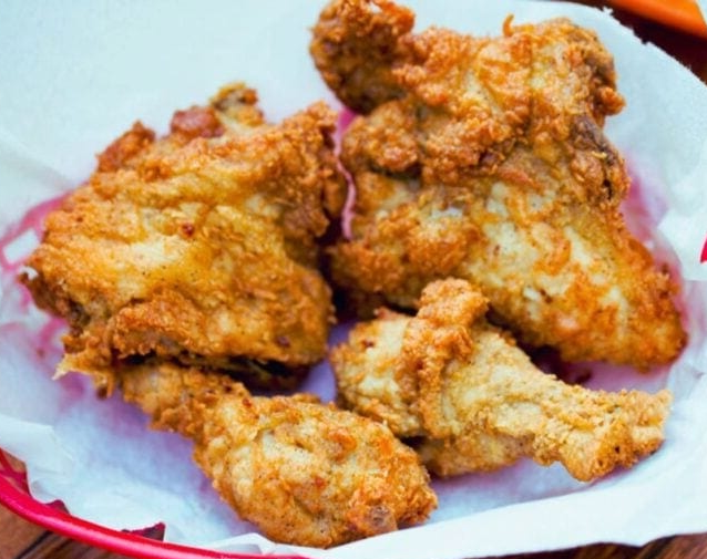 Pressure cooker fried chicken on a kitchen paper covered plate
