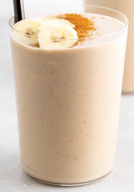 Peanut Butter Smoothie garnished with sliced banana and ground cinnamon