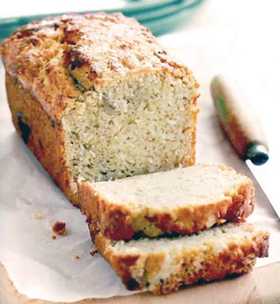 loaf of Philippines banana bread with two slices cut from the loaf and arranged in front