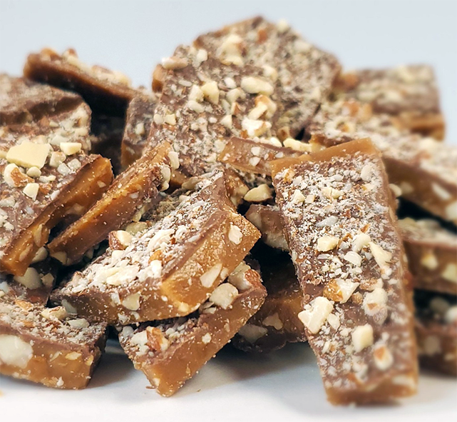 fragments of ground almond toffee piled on a worktop