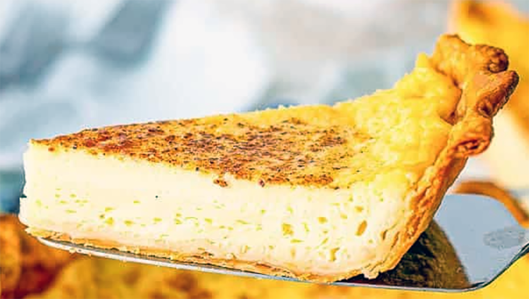 wedge of tart with an almond custard filling lifted on a cake slice