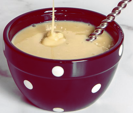 almond custard in a bowl with a stirrer