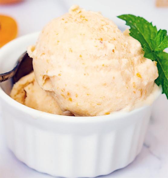 apricot ice in a ramekin garnished with a sprig of mint