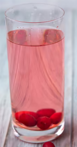barberry water in a tall glass with fresh barberries in the base
