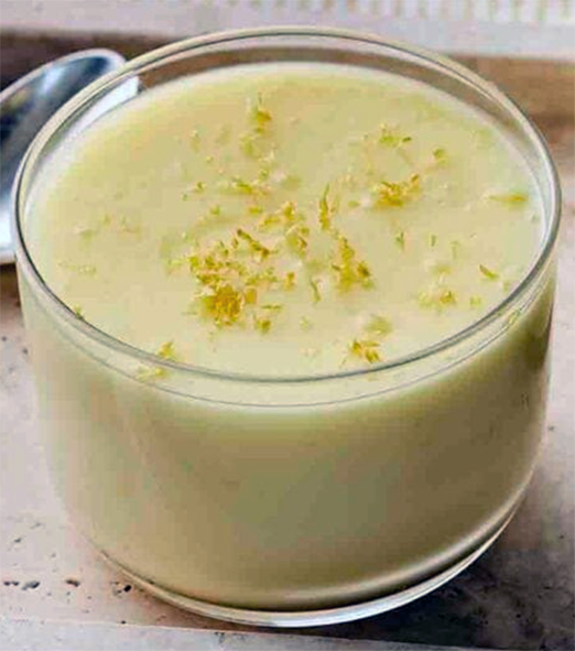 barley posset in a glass garnished with lemon zest