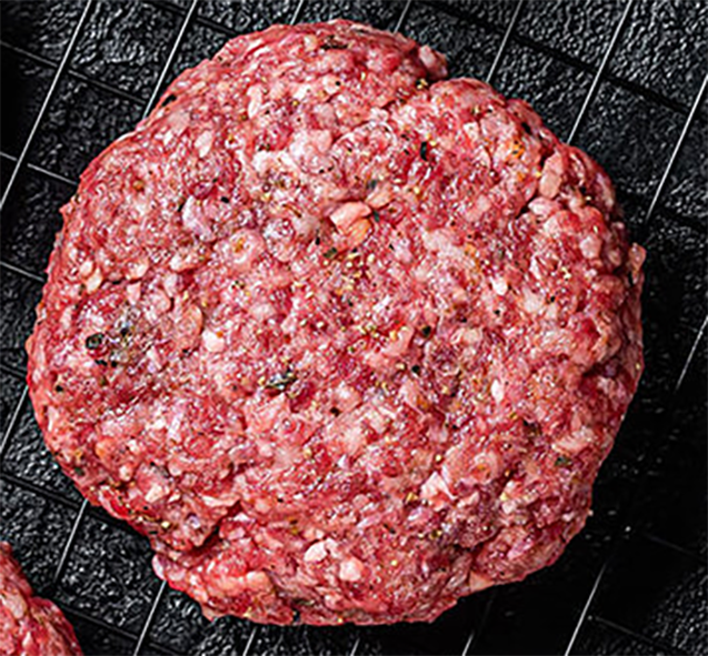 beef and bacon burger patty on a wire rack