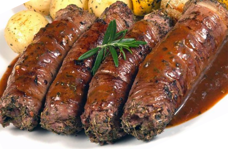 beef olives served on a plate with gravy