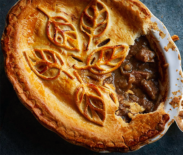 steak pie with a section removed to reveal the filling