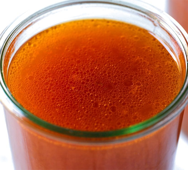 rich beef stock in a glass jar