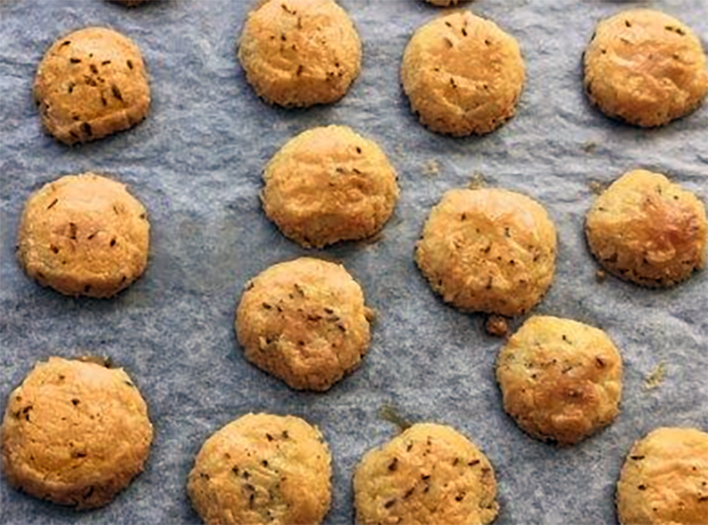 caraway seed drop biscuits on a sheet of greaseproof paper