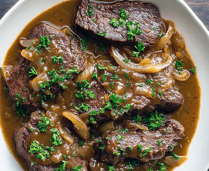 sliced beef re-heated in gravy with onions