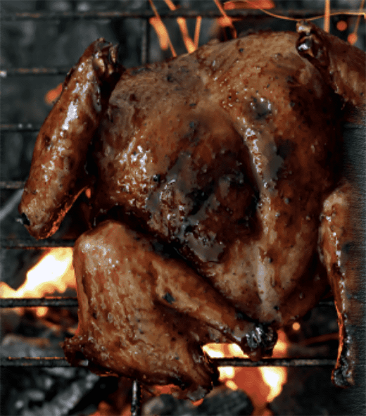 Marinated pigeon cooking on a barbecue