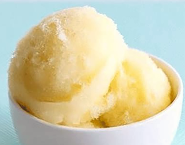 two scoops of pineapple sorbet in a bowl