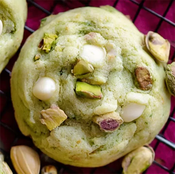 green-coloured cookies made with pistachio pudding mix with white chocolate and pistachios on a wire rack