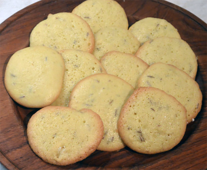 bisketello biscuits piled on a wooden plate