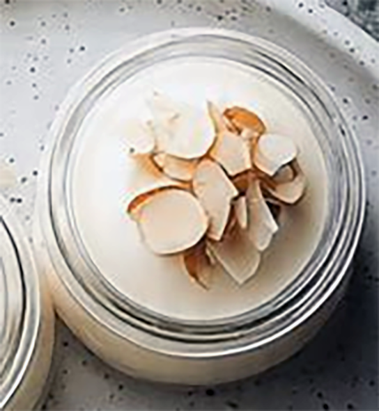 almond jelly in a small pot topped with toasted almond slivers