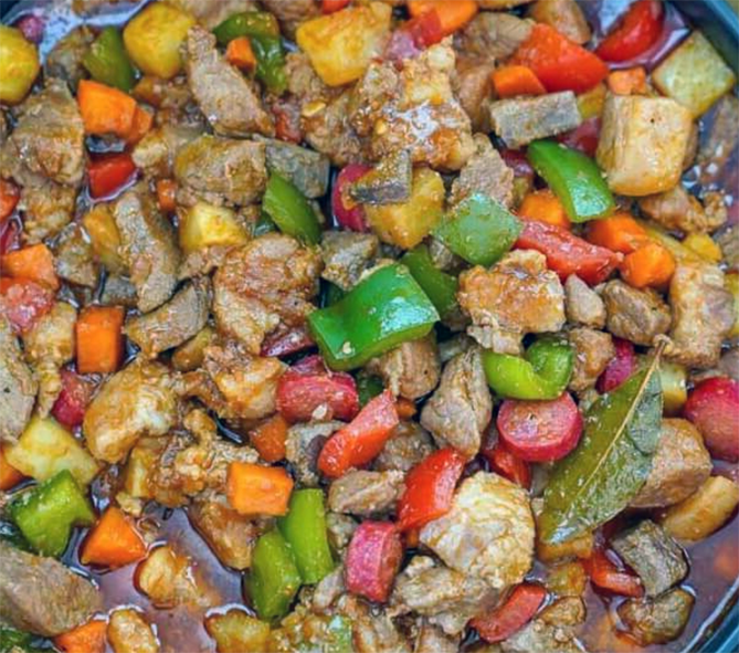 pork menudo with bell peppers in a serving dish