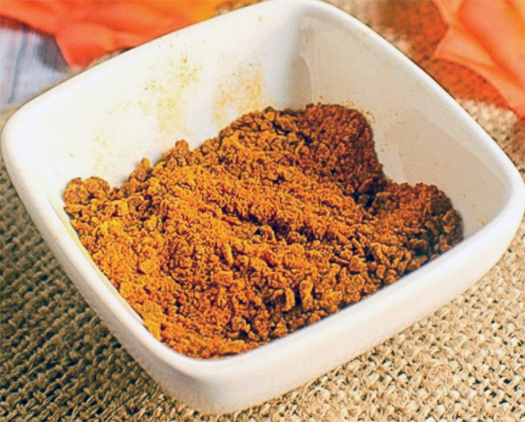 dried pumpkin flour in a small square bowl