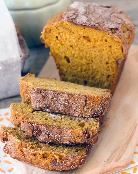 pumpkin flour bread loaf sliced on a wooden board