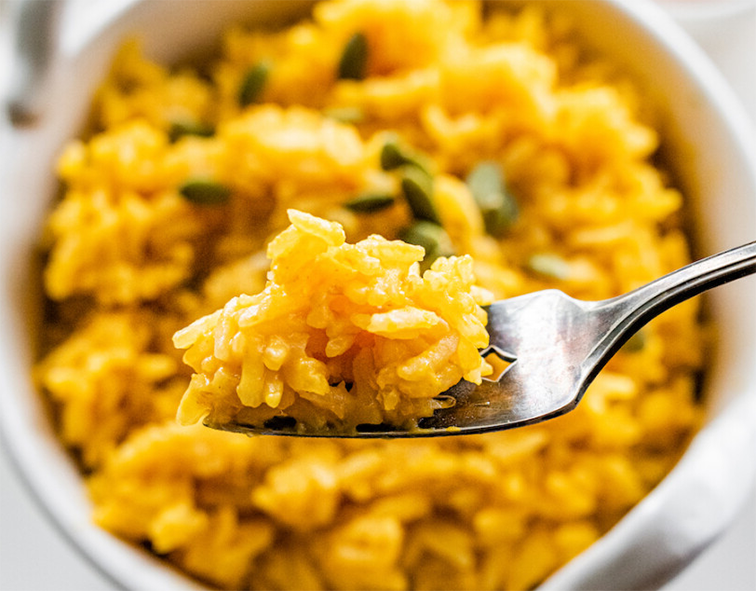 pumpkin rice in a bowl with a fork