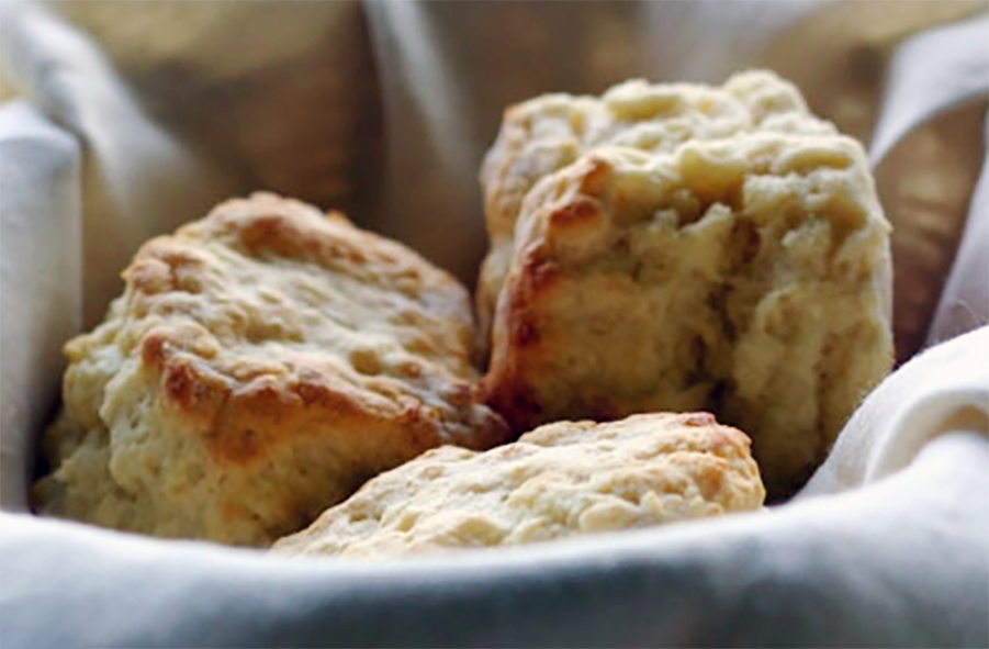 three pumpkin scones in a cloth-lined basket
